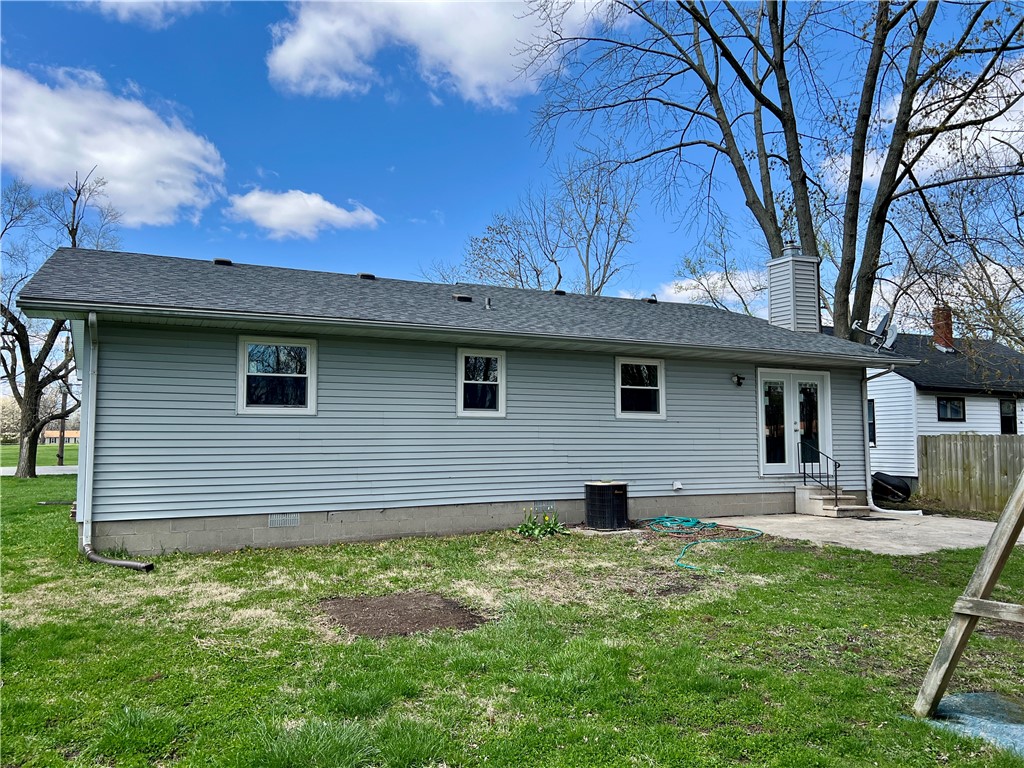 1272 South Lake Ridge Avenue Decatur, IL 62521 - Photo 4 of 20 a front view of a house with a garden