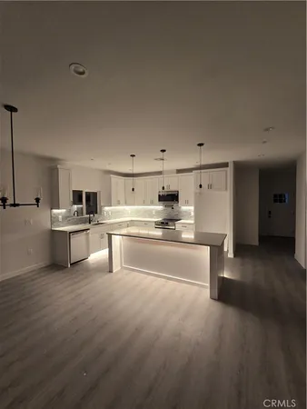 a kitchen with stainless steel appliances refrigerator sink and cabinets