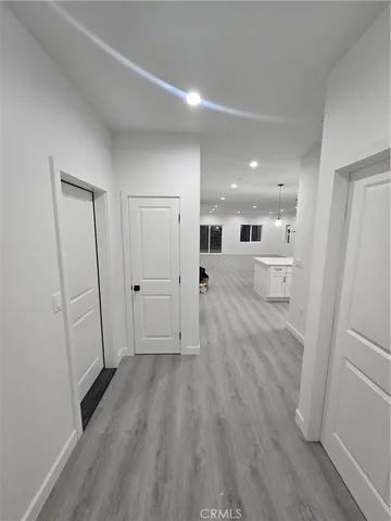 a view of a hallway with wooden floor