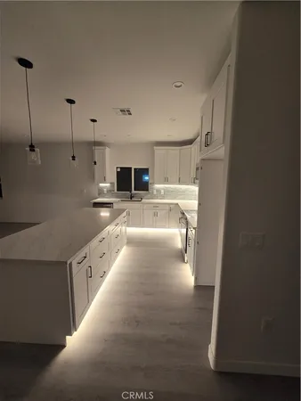 a large white kitchen with cabinets