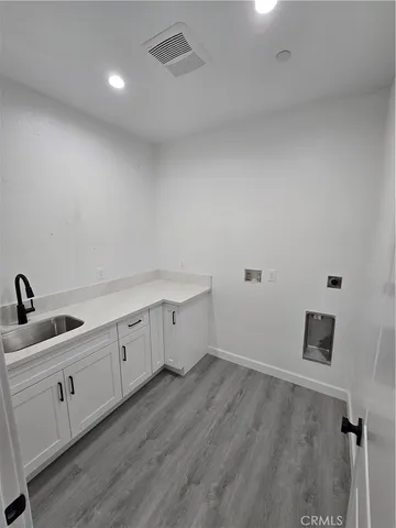 a kitchen with sink and cabinets