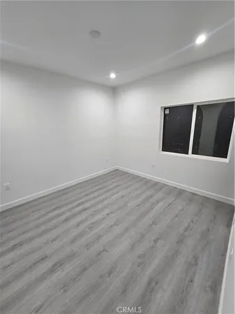 an empty room with wooden floor