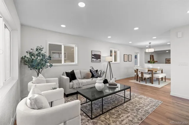 a living room with furniture and wooden floor