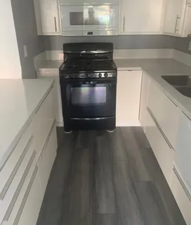 a kitchen with wooden floors and a stove