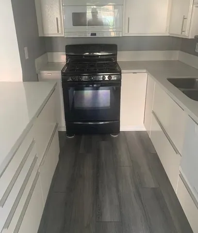 a kitchen with wooden floors and a stove