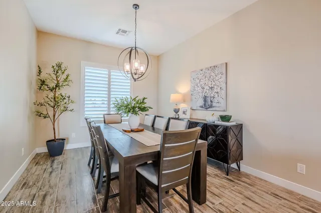 a kitchen with kitchen island granite countertop a sink appliances and wooden floor