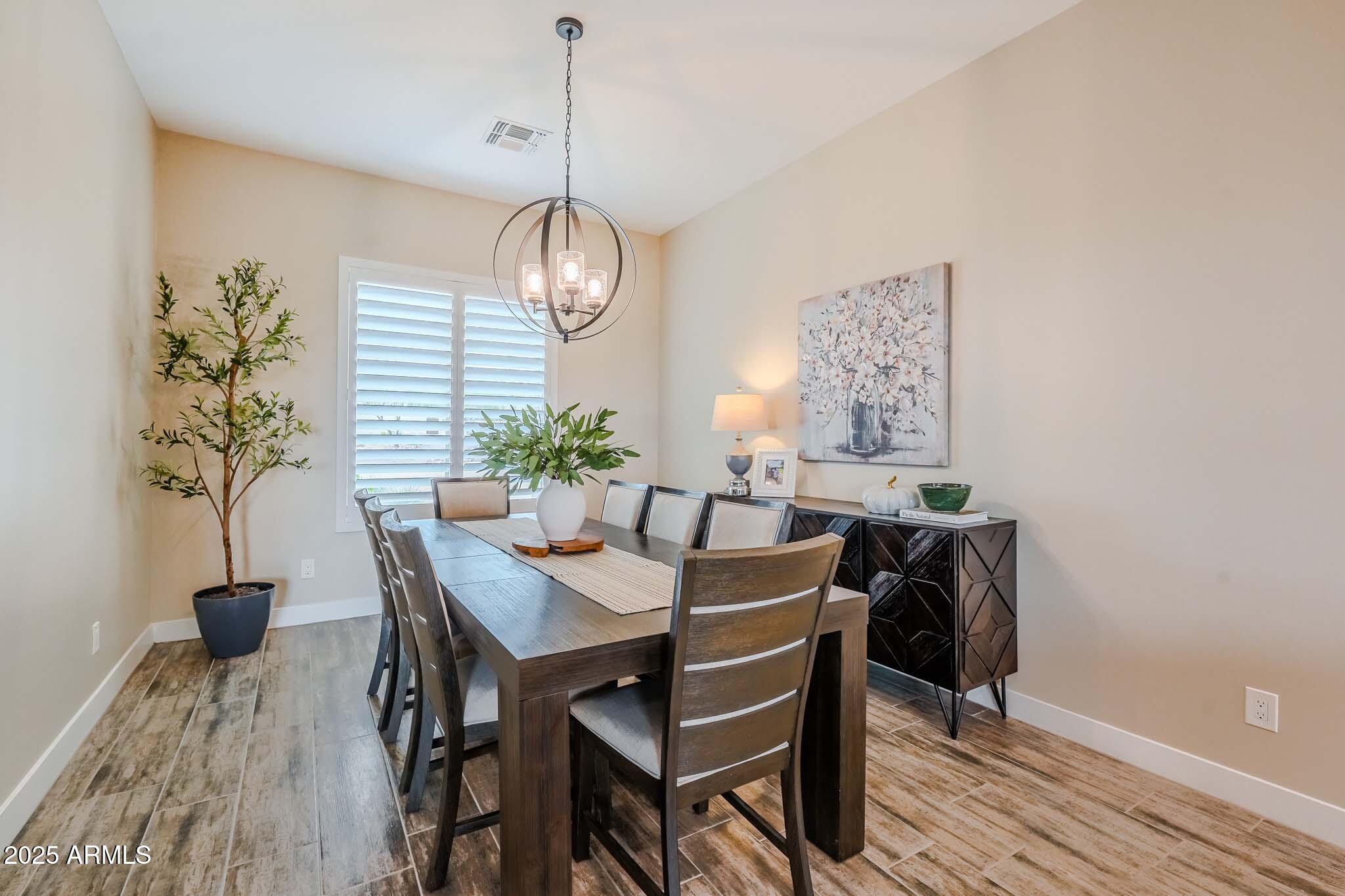2049 East Gaffney Road New River, AZ 85087 - Photo 11 of 77 a view of a dining room with furniture window and wooden floor
