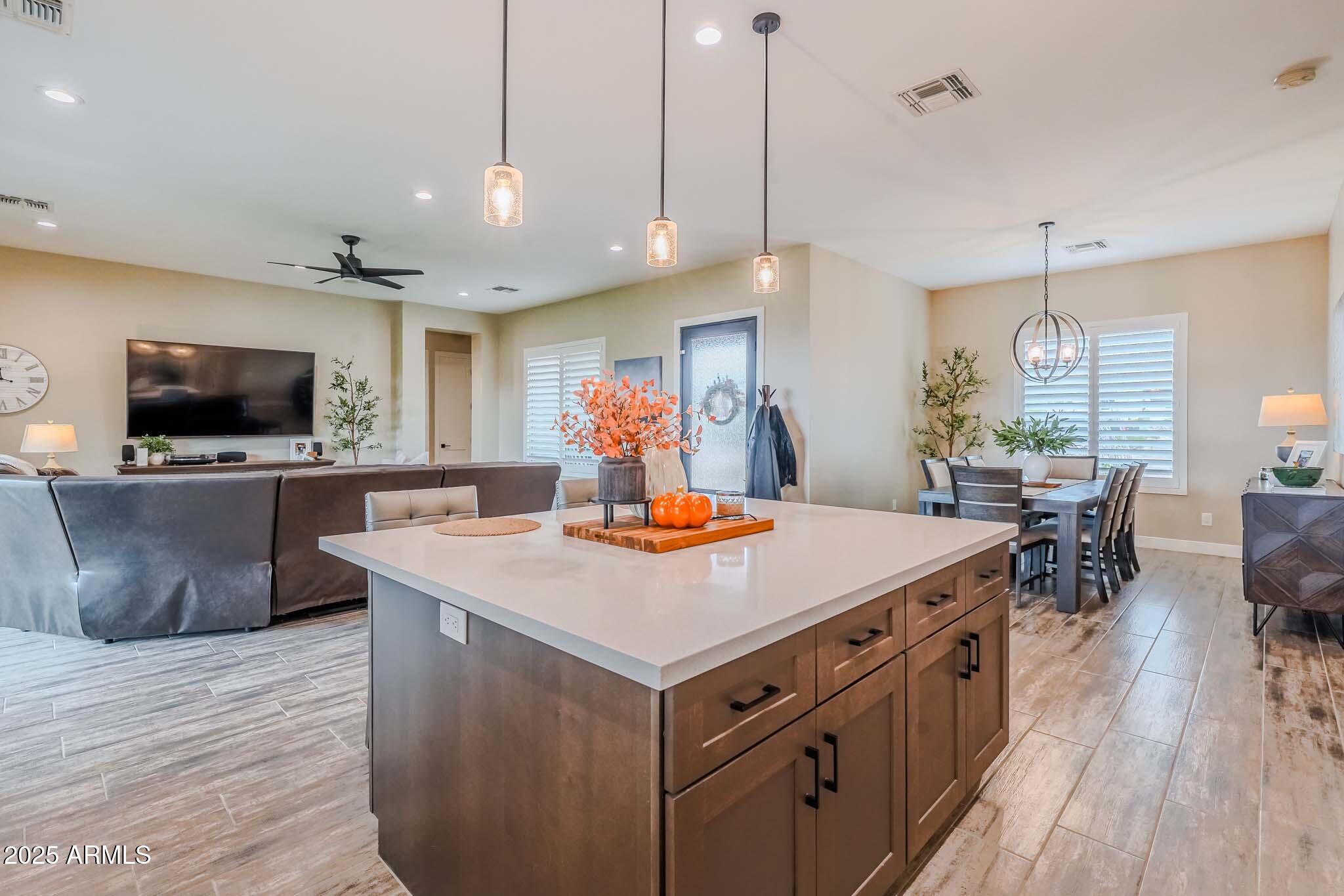 2049 East Gaffney Road New River, AZ 85087 - Photo 12 of 77 a kitchen with kitchen island a sink counter top space a sink and wooden floor
