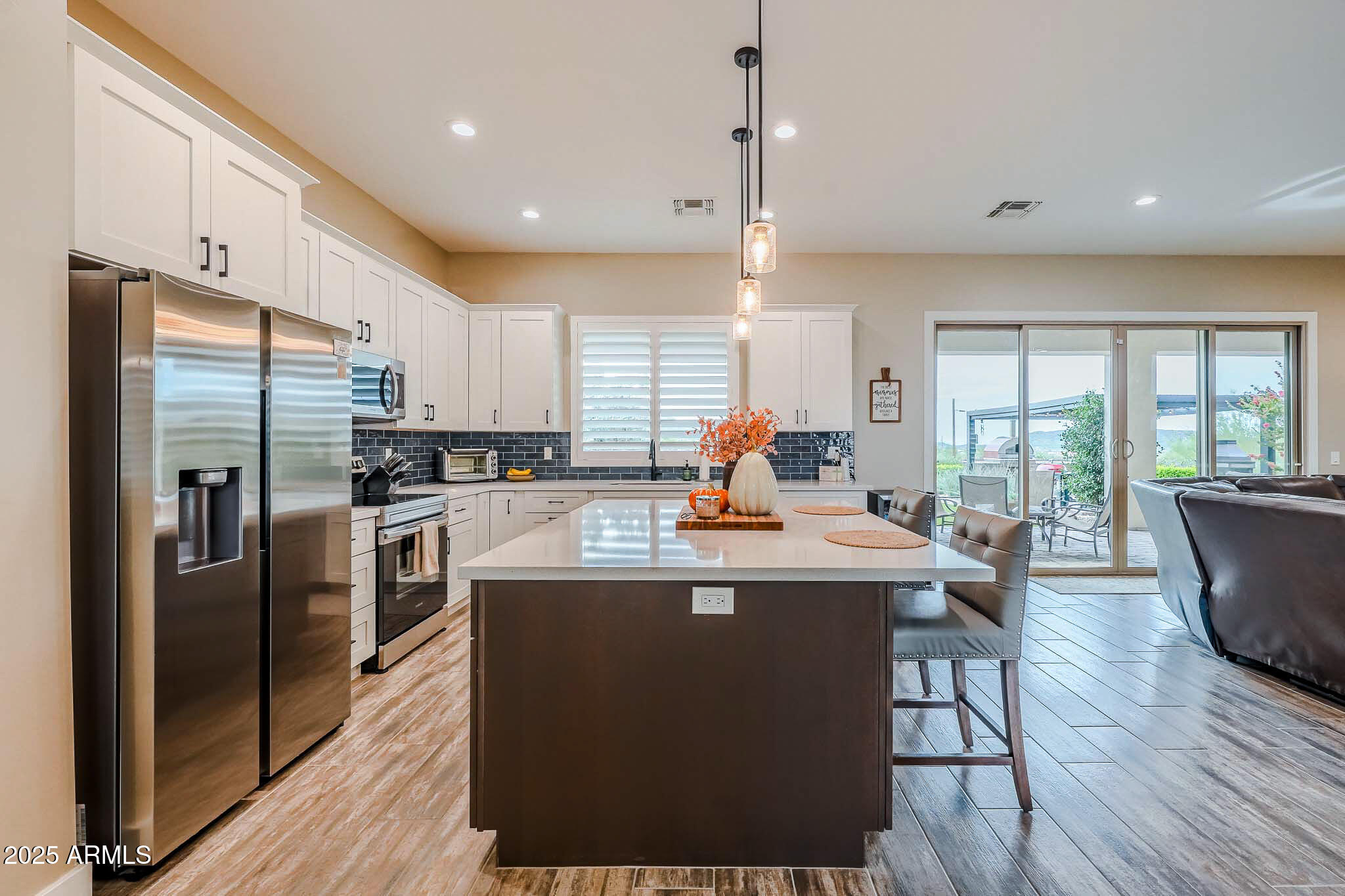 2049 East Gaffney Road New River, AZ 85087 - Photo 15 of 77 a view of a kitchen with kitchen island a counter top space a sink stainless steel appliances and cabinets