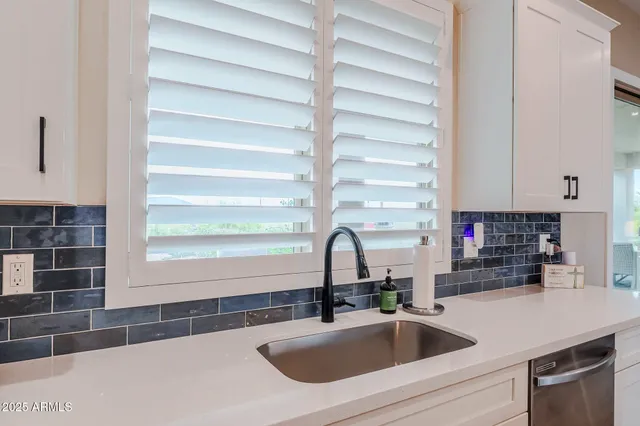 a utility room with cabinets washer and dryer