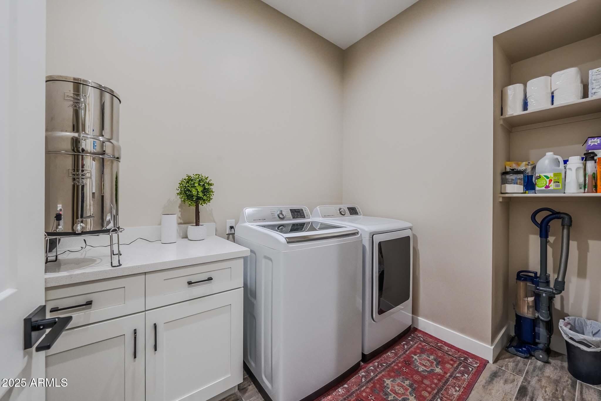 2049 East Gaffney Road New River, AZ 85087 - Photo 23 of 77 a utility room with cabinets washer and dryer