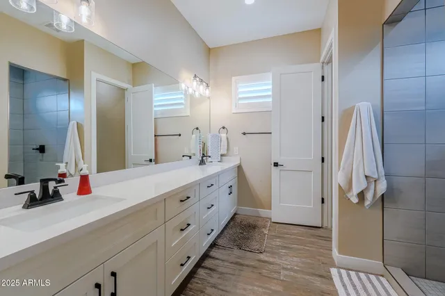 a bathroom with a sink a toilet and a mirror