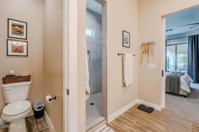 a bathroom with a shower a toilet and a shower