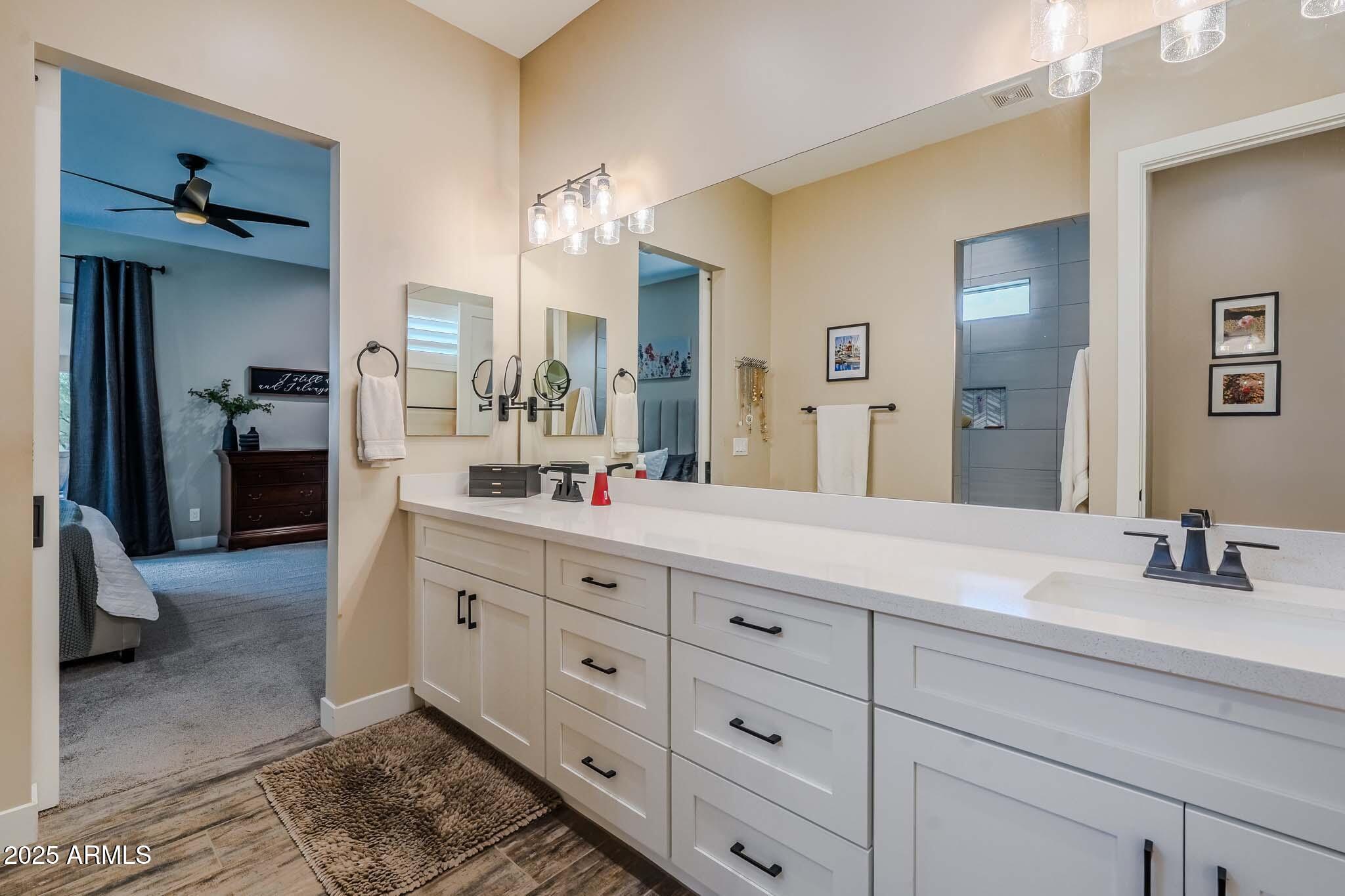 2049 East Gaffney Road New River, AZ 85087 - Photo 32 of 77 a bathroom with double vanity sink and a mirror