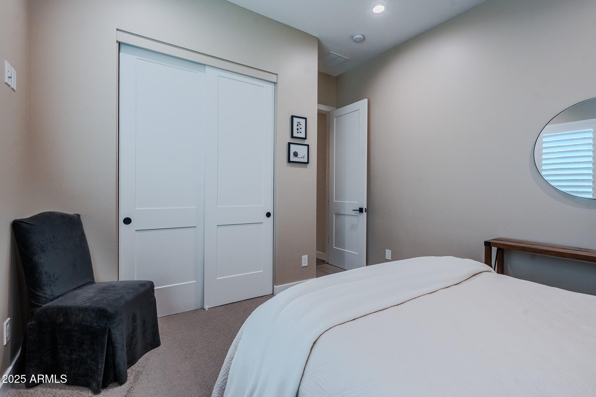 2049 East Gaffney Road New River, AZ 85087 - Photo 34 of 77 a bedroom with a bed and a chair