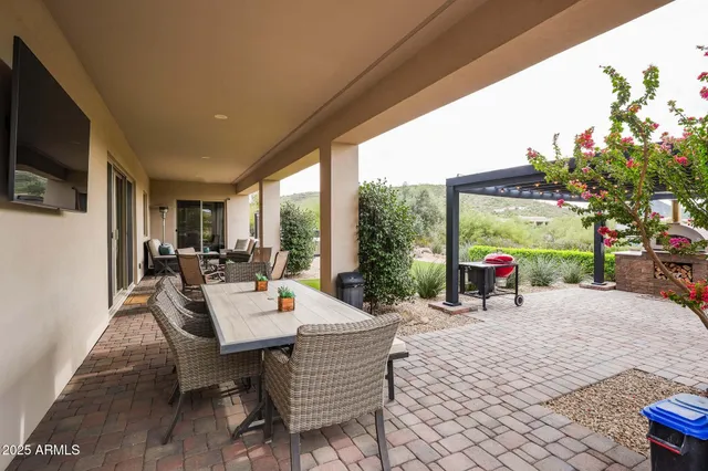 a view of a house with backyard porch and furniture
