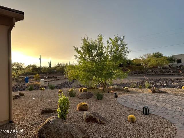 an aerial view of a house with a garden and fire pit