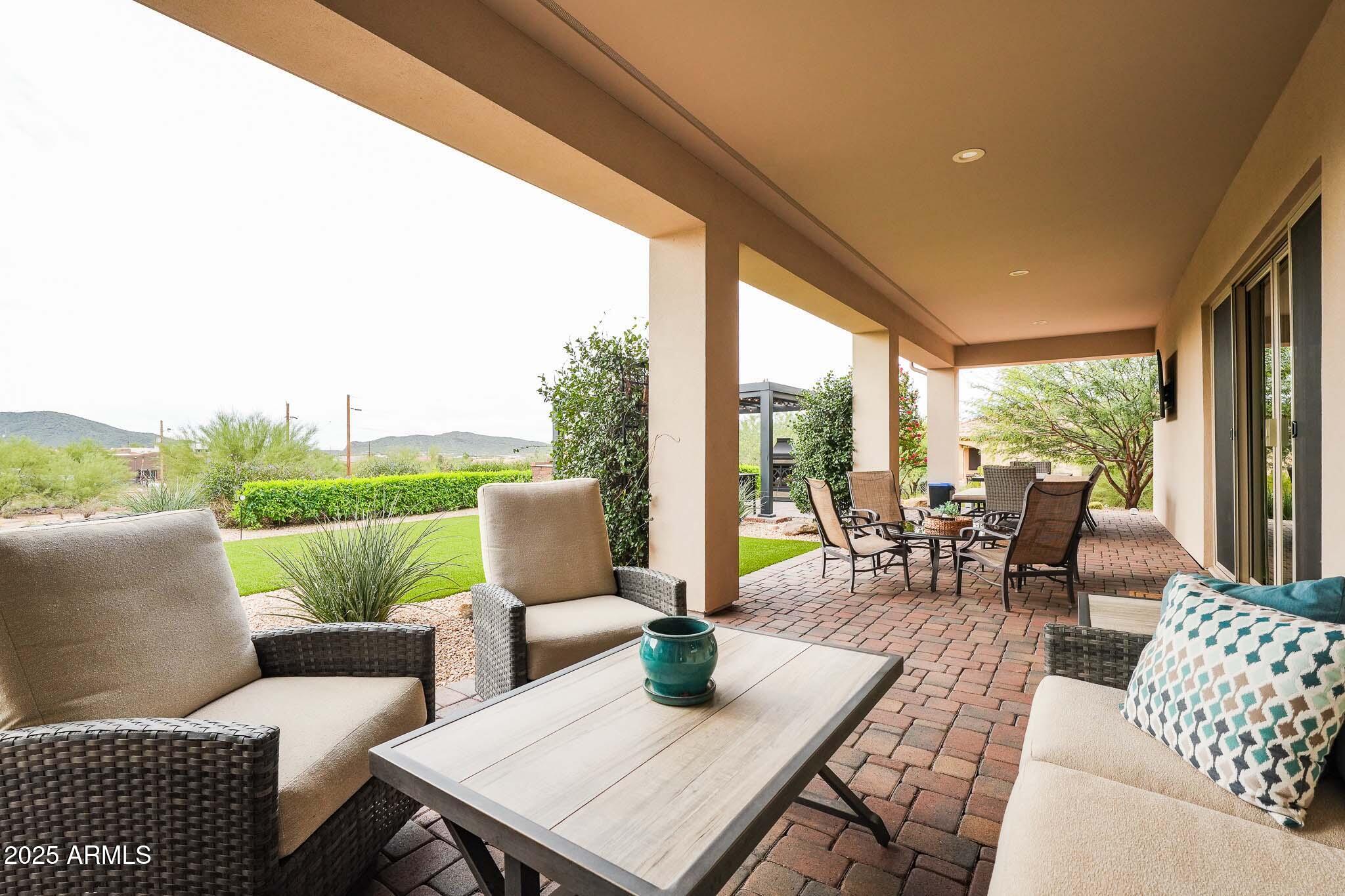 2049 East Gaffney Road New River, AZ 85087 - Photo 41 of 77 a living room with patio furniture and a garden