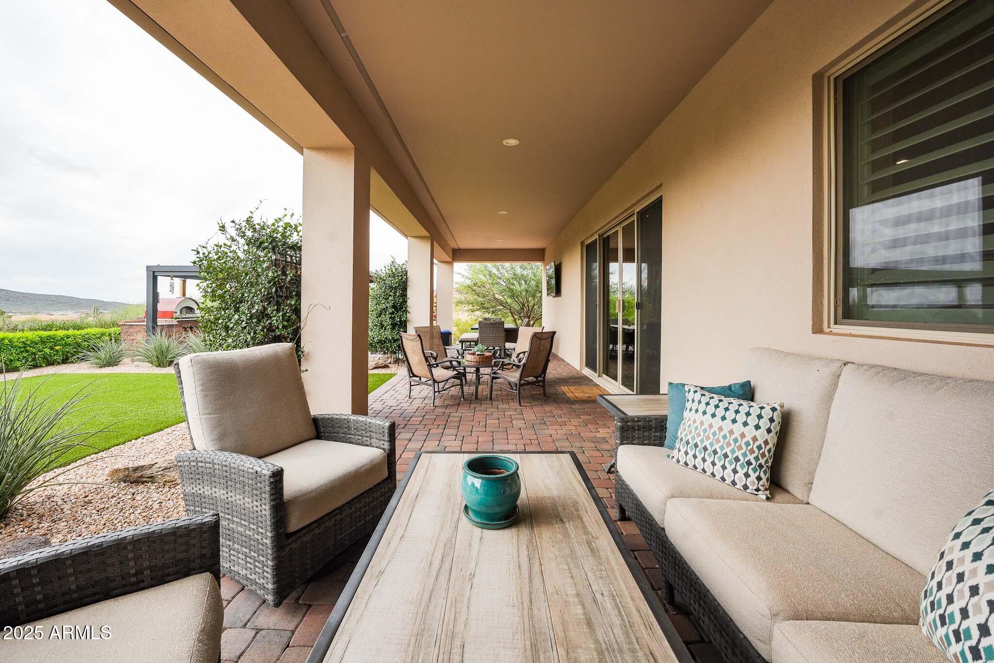 2049 East Gaffney Road New River, AZ 85087 - Photo 42 of 77 a view of a patio with couches chairs and a big yard