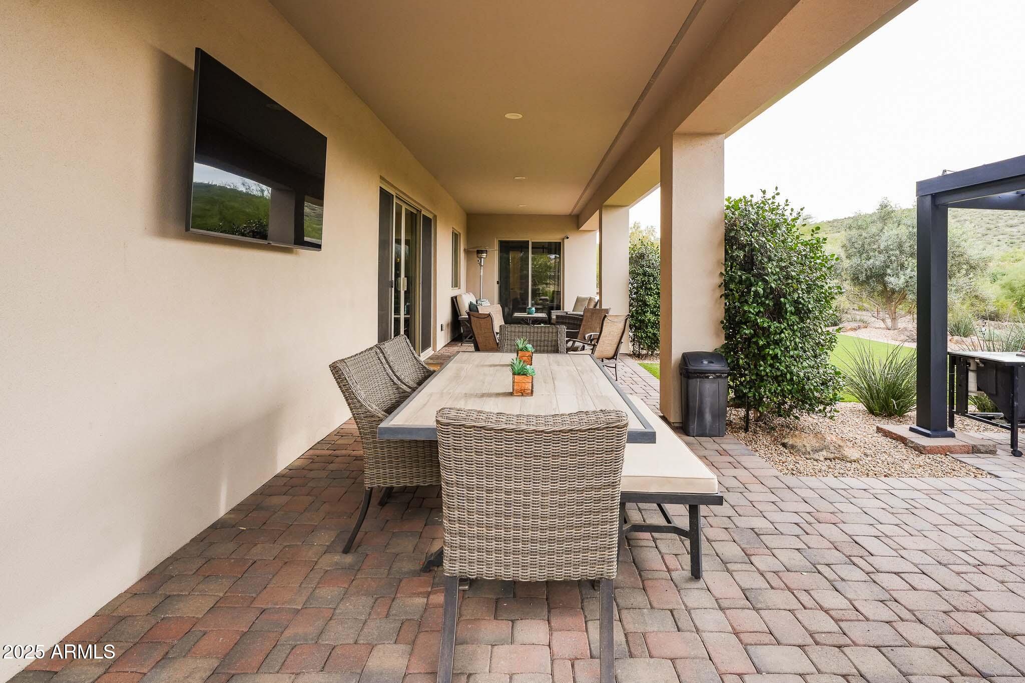 2049 East Gaffney Road New River, AZ 85087 - Photo 44 of 77 a dinning table and chairs in patio of the house