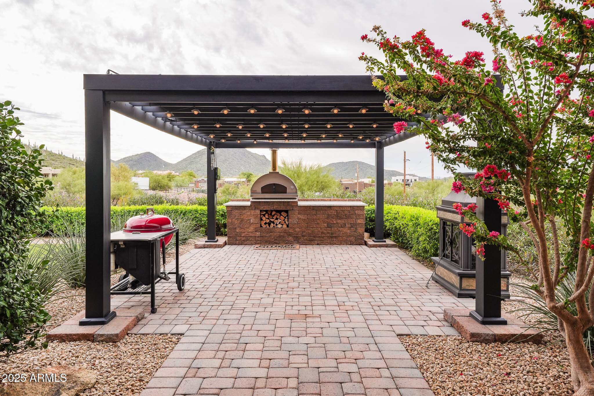 2049 East Gaffney Road New River, AZ 85087 - Photo 46 of 77 a backyard of a house with barbeque oven table and chairs