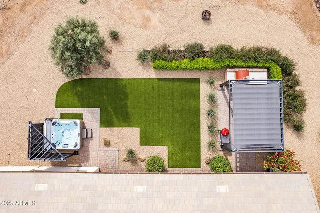a living room with furniture a flat screen tv and a large window