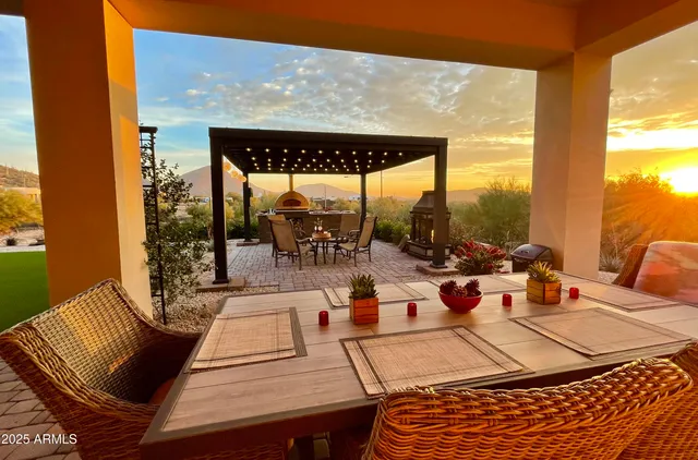 a living room with furniture kitchen view and a potted plant