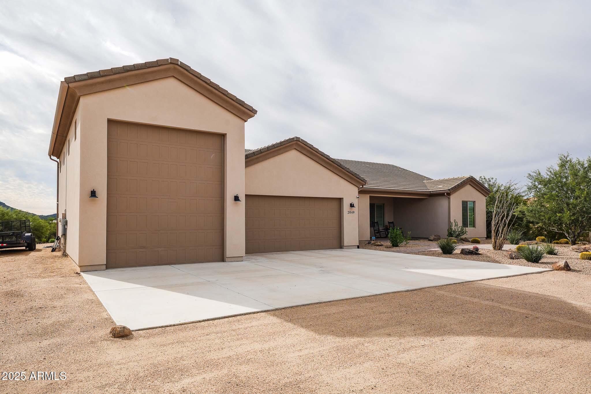 2049 East Gaffney Road New River, AZ 85087 - Photo 73 of 77 a front view of a house with a yard and garage