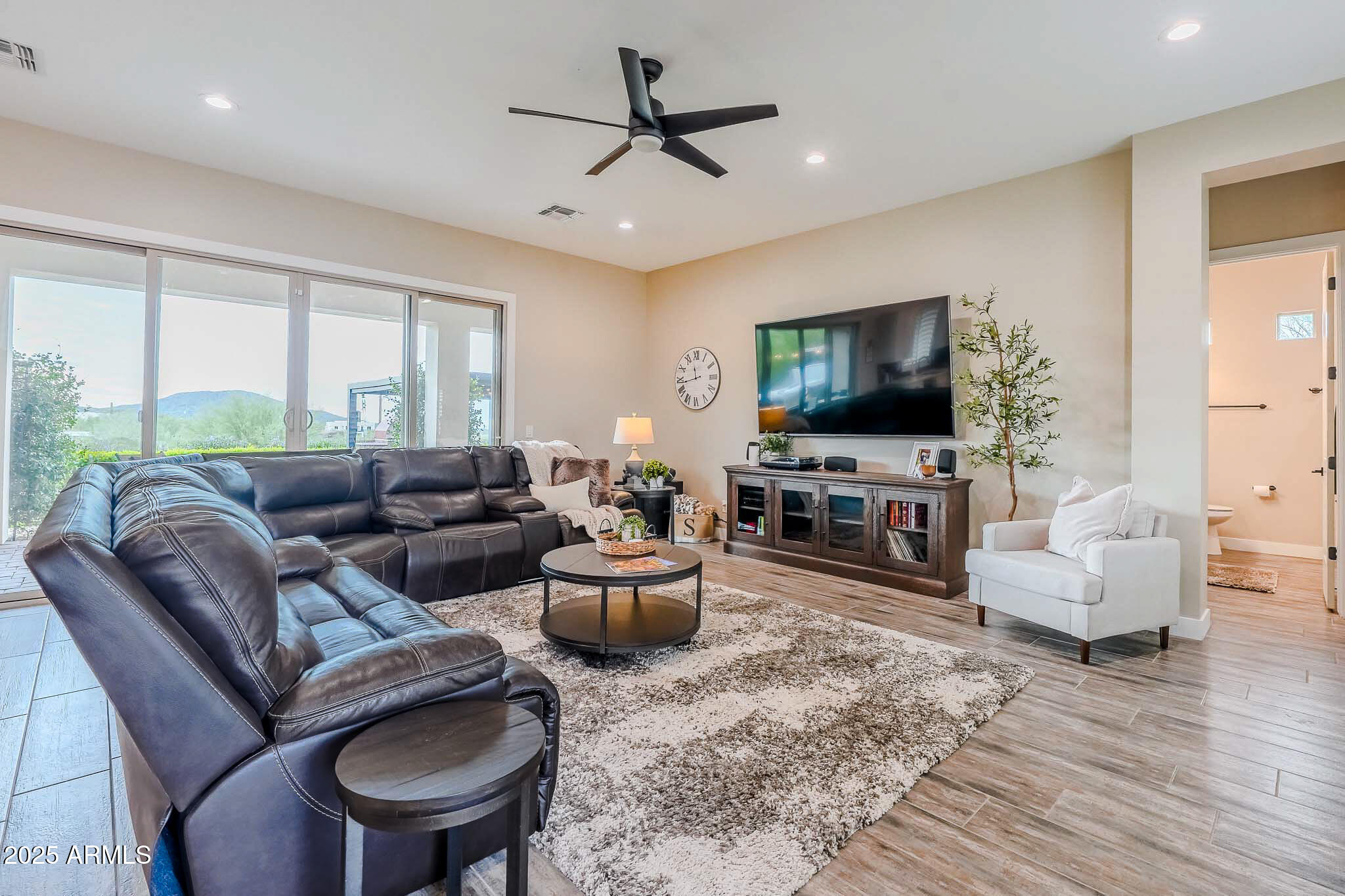 2049 East Gaffney Road New River, AZ 85087 - Photo 8 of 77 a living room with furniture a flat screen tv and a large window