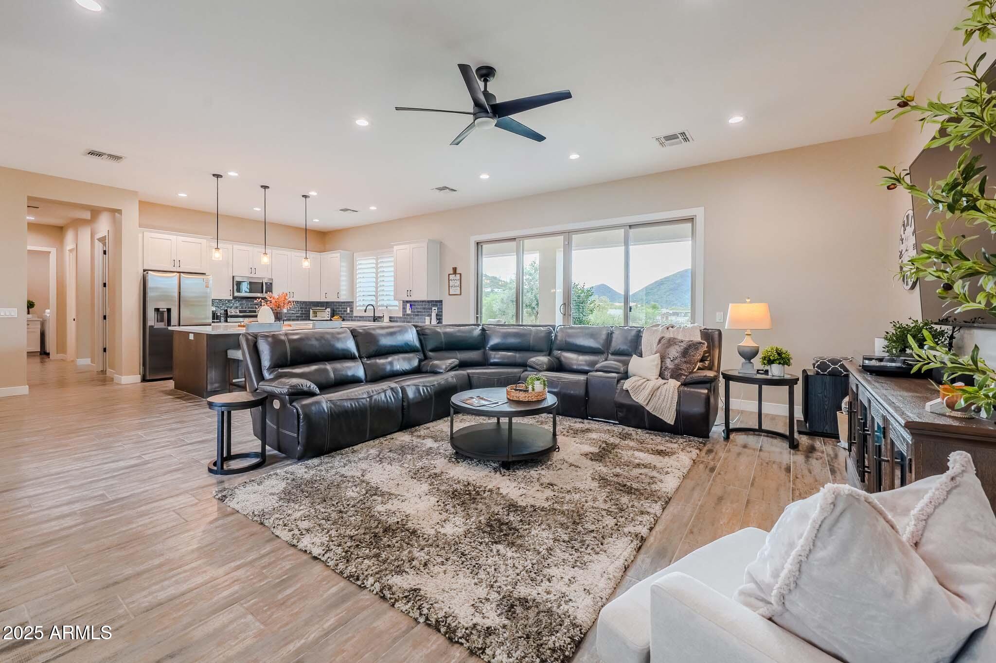 2049 East Gaffney Road New River, AZ 85087 - Photo 9 of 77 a living room with furniture kitchen view and a potted plant