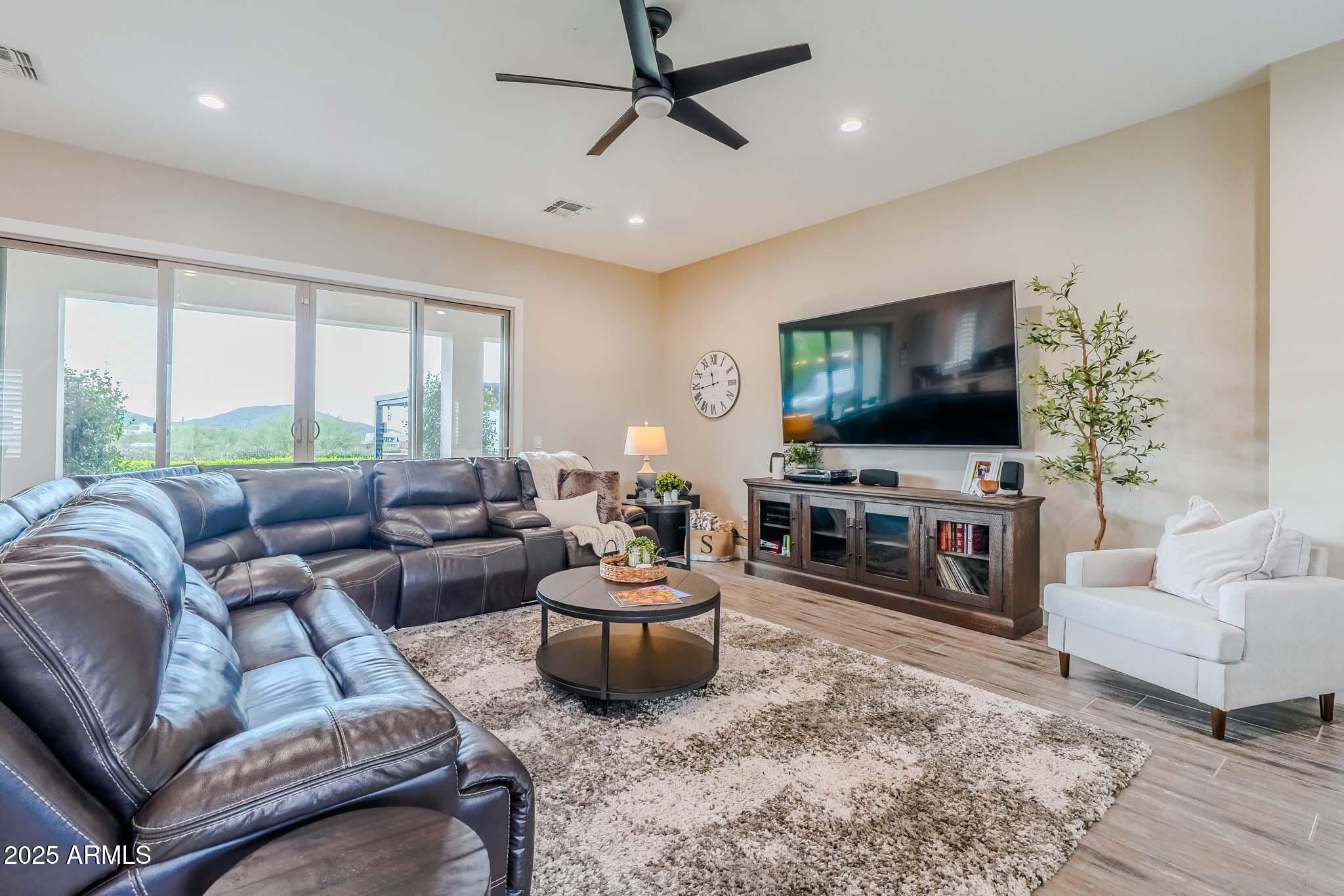 2049 East Gaffney Road New River, AZ 85087 - Photo 10 of 77 a living room with furniture and a flat screen tv