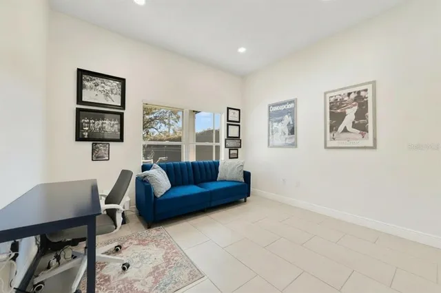 a living room with furniture and painting on the wall