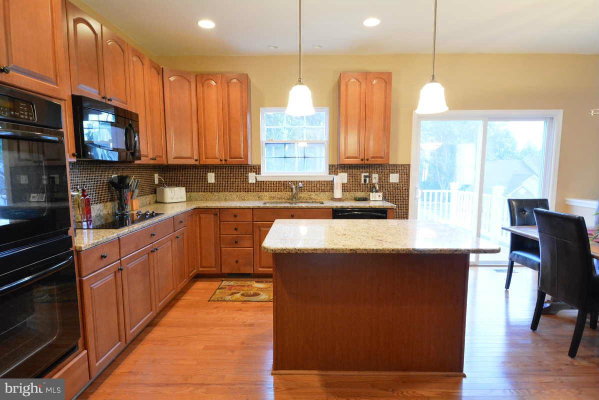 2016 Baythorne Road Prince Frederick, MD 20678 - Photo 12 of 30 a kitchen with stainless steel appliances granite countertop wooden cabinets a sink and dishwasher