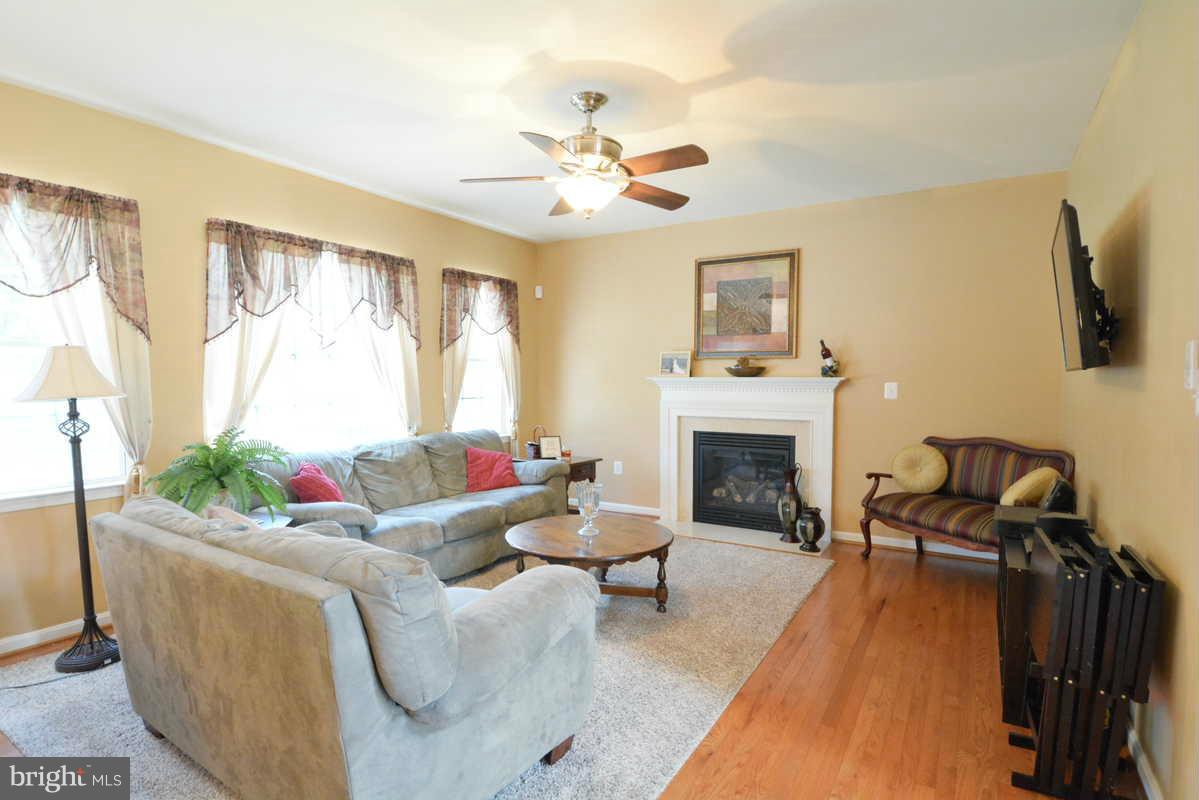 2016 Baythorne Road Prince Frederick, MD 20678 - Photo 16 of 30 a living room with furniture and a fireplace