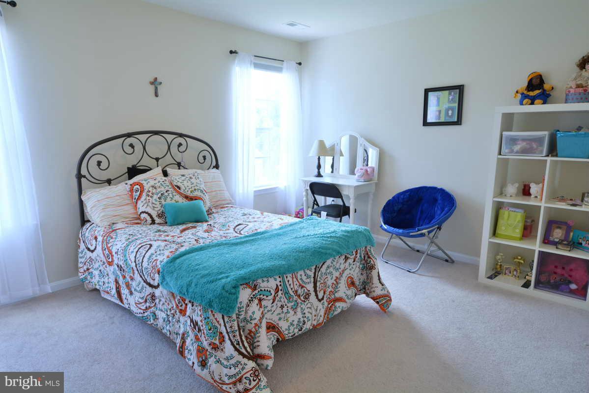 2016 Baythorne Road Prince Frederick, MD 20678 - Photo 20 of 30 a bedroom with a bed a dresser and book shelf