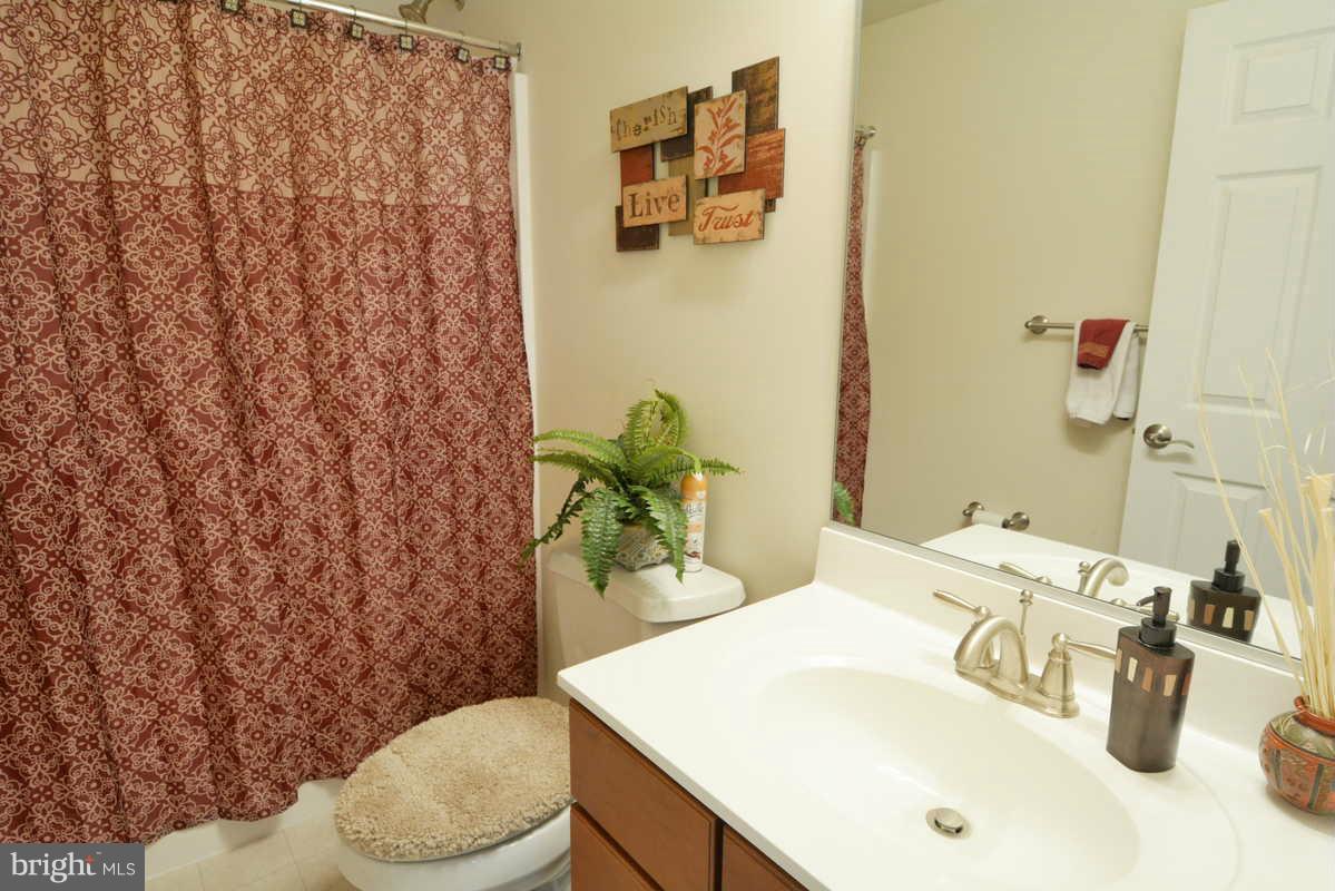2016 Baythorne Road Prince Frederick, MD 20678 - Photo 26 of 30 a bathroom with a sink a toilet and shower curtain