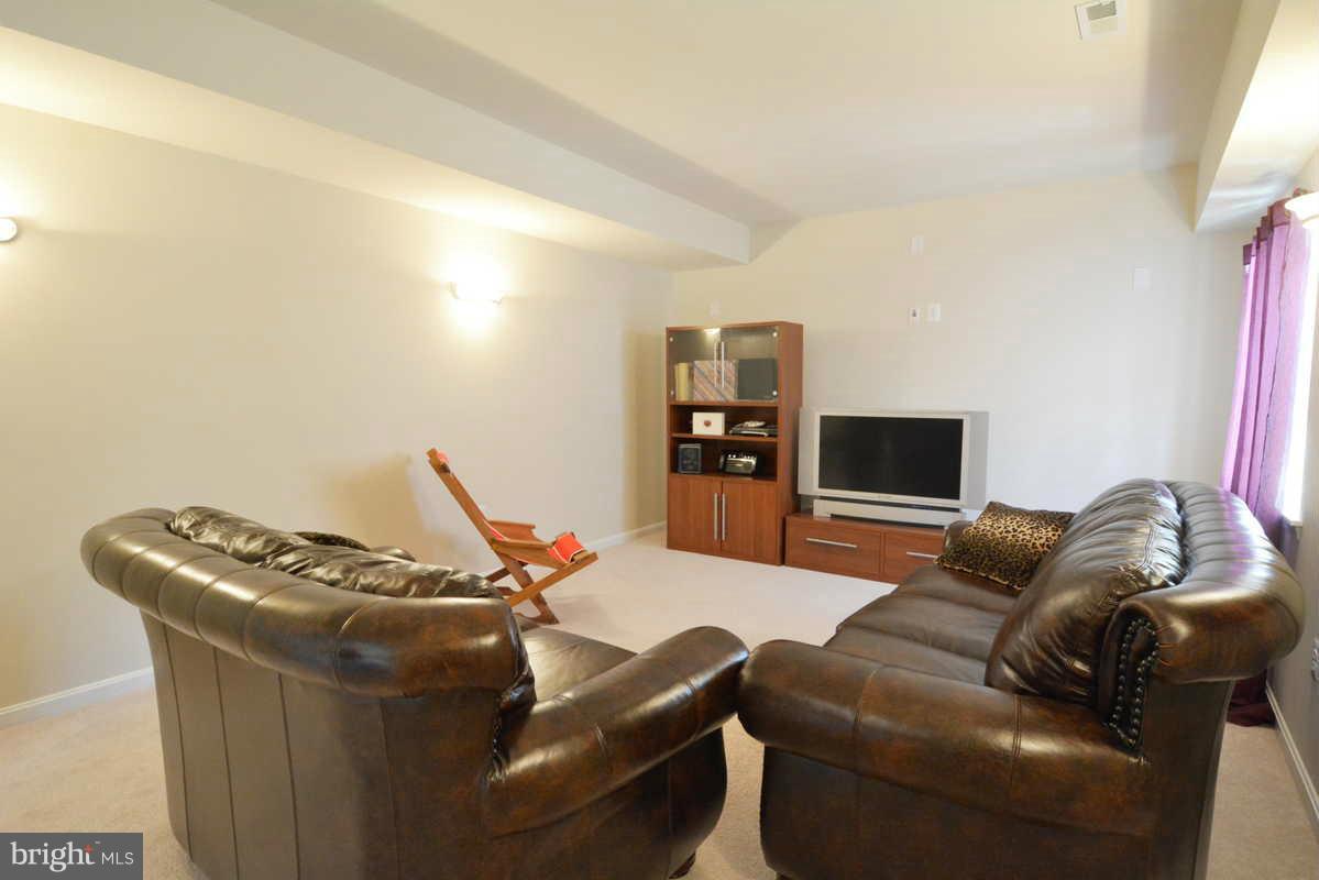 2016 Baythorne Road Prince Frederick, MD 20678 - Photo 28 of 30 a living room with furniture and a flat screen tv