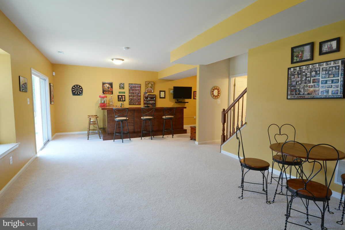 2016 Baythorne Road Prince Frederick, MD 20678 - Photo 29 of 30 a living room with furniture and a flat screen tv