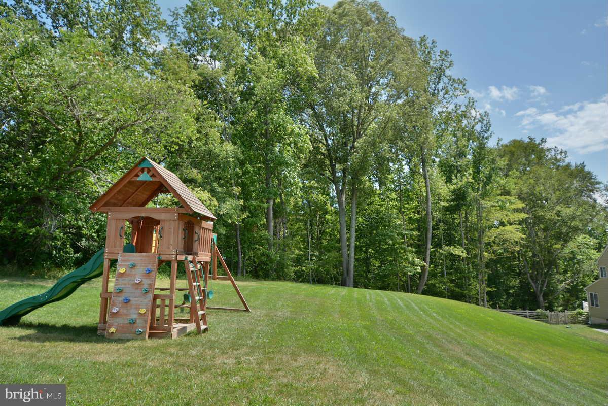 2016 Baythorne Road Prince Frederick, MD 20678 - Photo 7 of 30 a front view of a house with a yard and trees