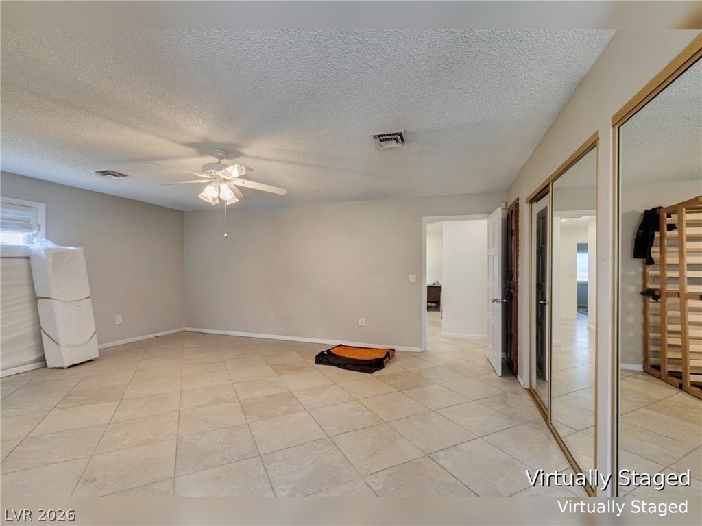892 North Hollywood Boulevard Las Vegas, NV 89110 - Photo 34 of 81 This spacious room features a ceiling fan and elegant tile flooring.
