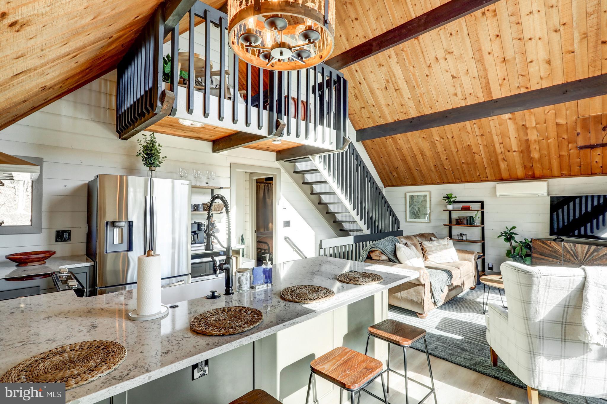 120 Brompton Road Hummelstown, PA 17036 - Photo 23 of 55 a kitchen with stainless steel appliances kitchen island granite countertop a table chairs in it and wooden floors