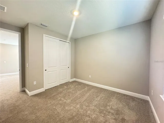 an empty room with closet area