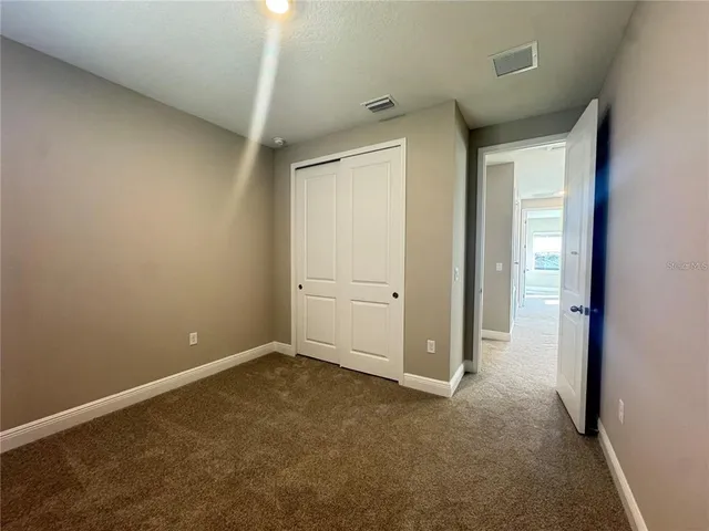 a bathroom with a sink a toilet a mirror and shower