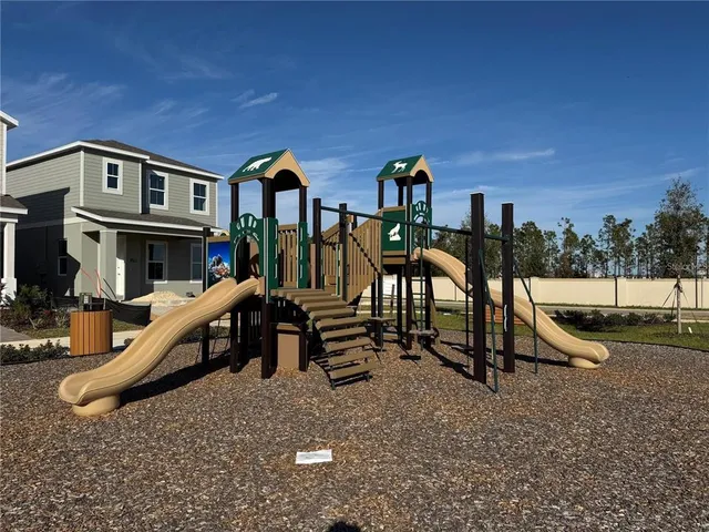 a view of a house with swimming pool and sitting area