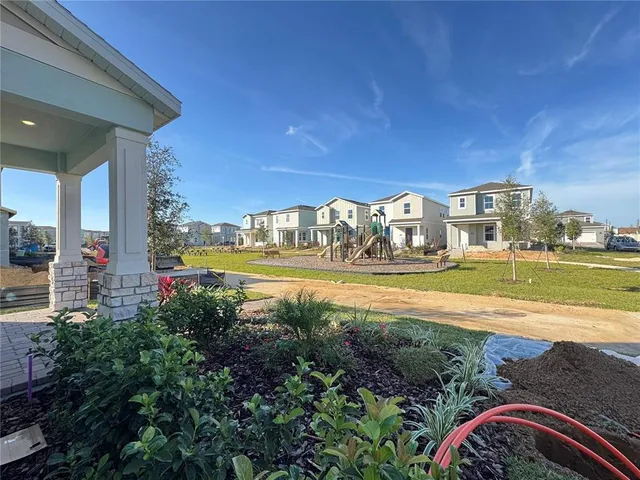 a view of a street with a house in the background