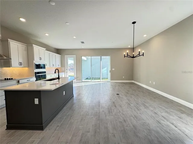 a kitchen with wooden floors and cabinets
