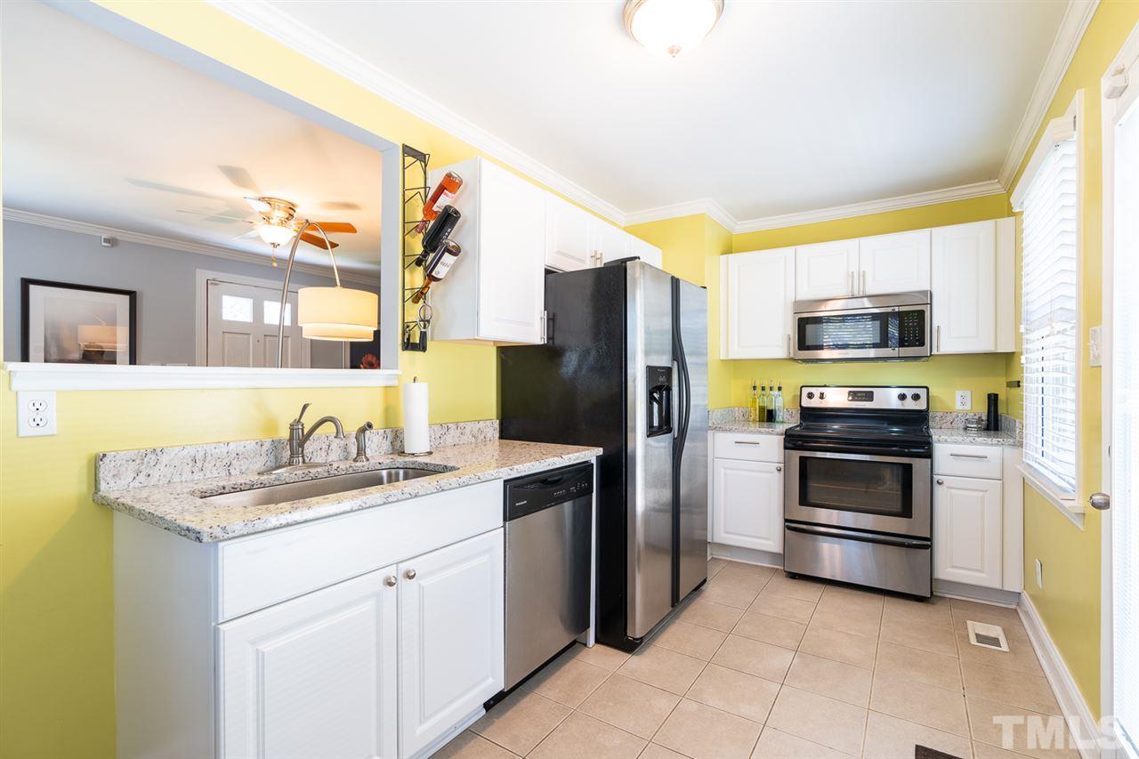 701 North King Charles Road Raleigh, NC 27610 - Photo 13 of 28 a kitchen with stainless steel appliances a stove a sink a microwave a refrigerator and a window