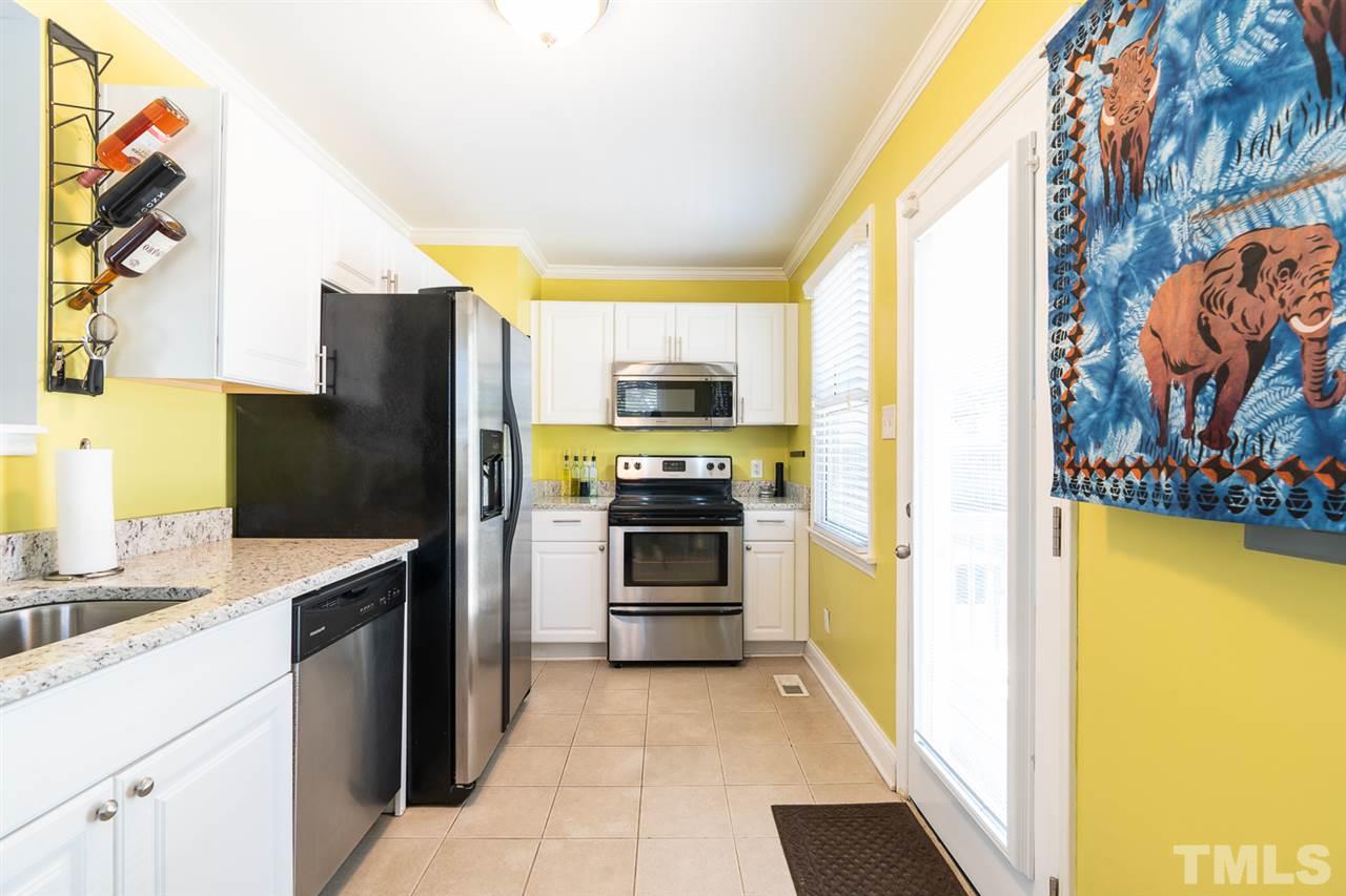 701 North King Charles Road Raleigh, NC 27610 - Photo 14 of 28 a kitchen with a refrigerator and a stove