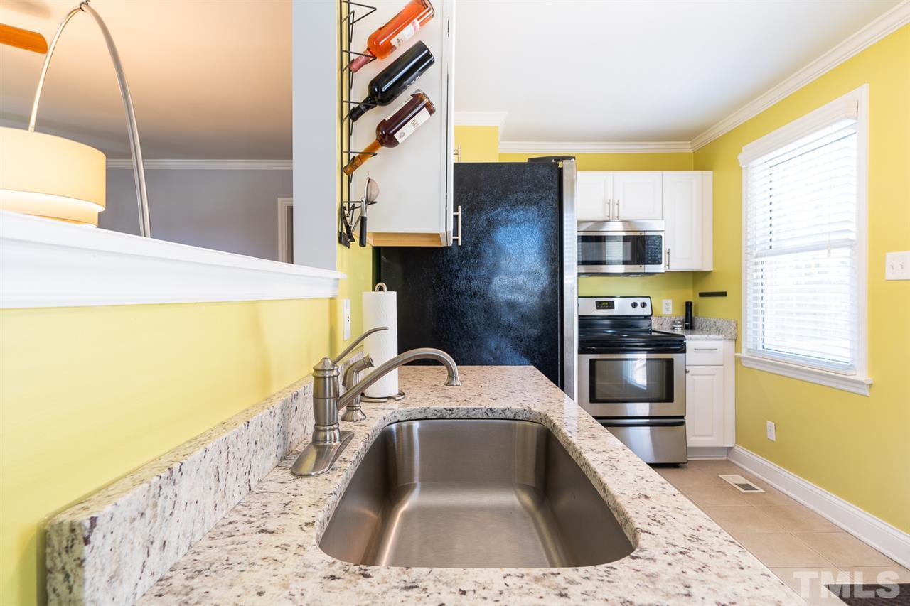 701 North King Charles Road Raleigh, NC 27610 - Photo 15 of 28 a kitchen with a sink and a refrigerator