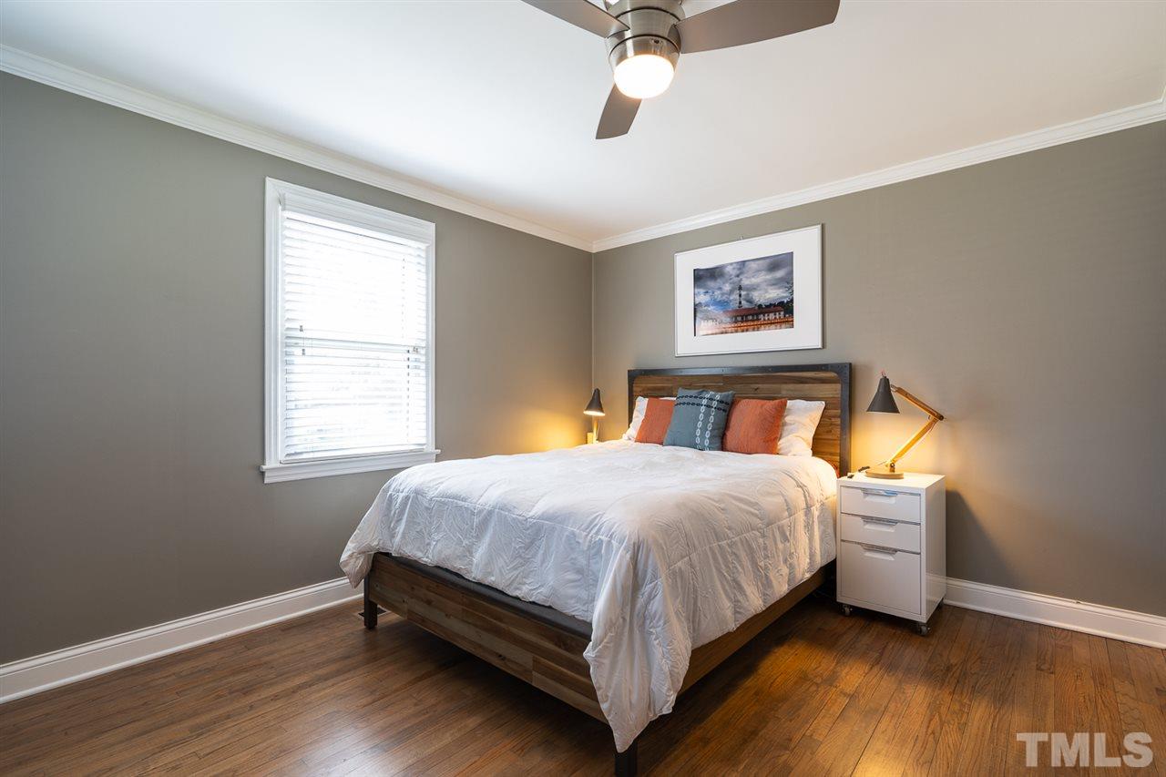701 North King Charles Road Raleigh, NC 27610 - Photo 17 of 28 a bedroom with a bed wooden floor and window